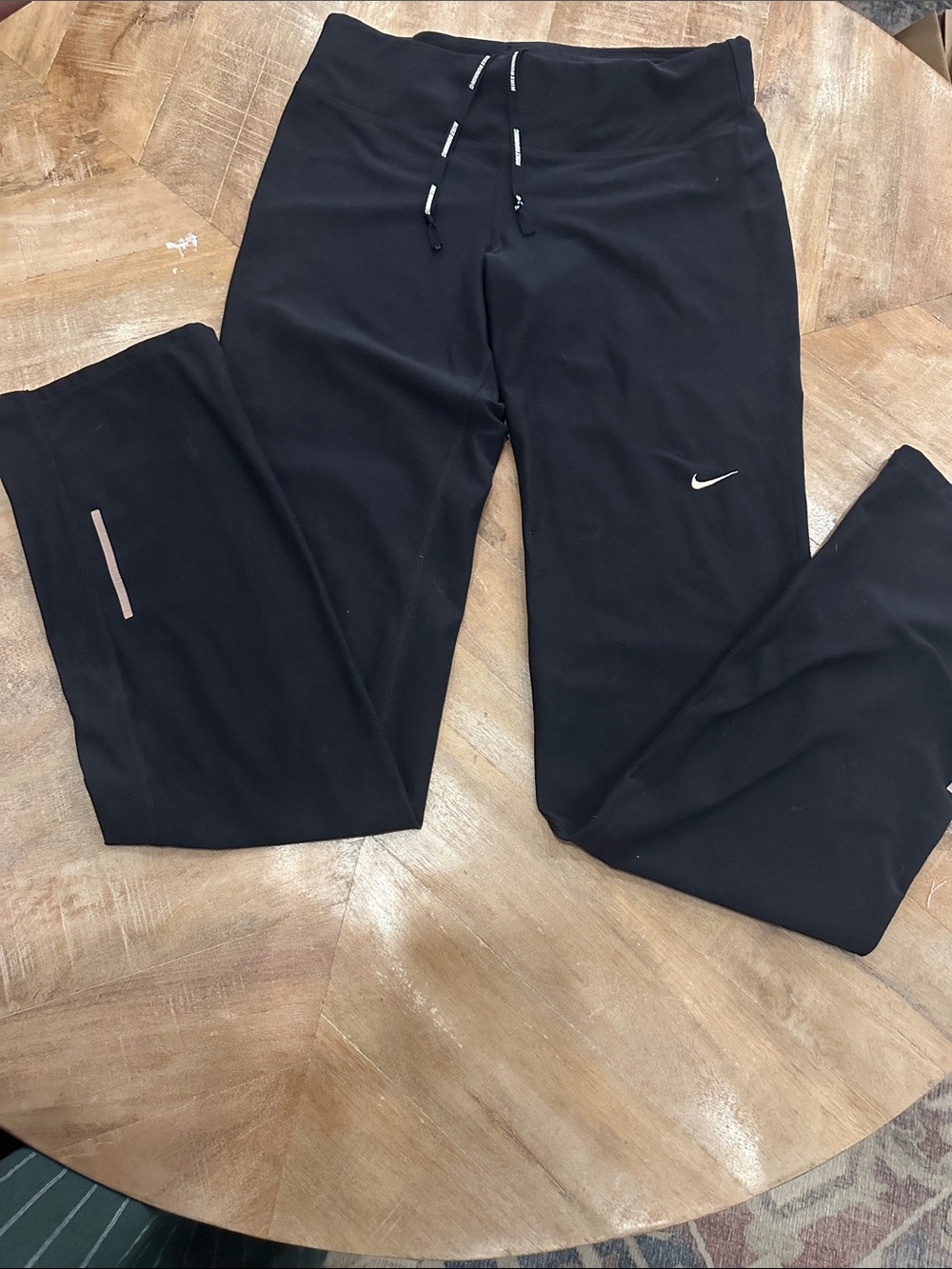 Nike Black Workout Pants with bronze Swoosh and bronze lines on the back calves